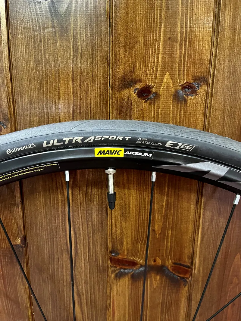 Mavic Aksium front disc wheel CL 100x12mm inc.  Continental Ultrasport 25mm tyre. -1